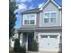 Charming two-story home featuring gray siding, a white garage door, and a well-maintained landscaped yard at 15005 Savannah Hall Dr # 72, Charlotte, NC 28273