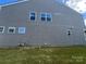 Exterior of a house with vinyl siding, multiple windows, and a green lawn at 15005 Savannah Hall Dr # 72, Charlotte, NC 28273