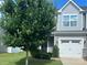 Charming home with a two-car garage, manicured lawn, and mature tree in a well-maintained community at 15005 Savannah Hall Dr # 72, Charlotte, NC 28273