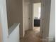 Hallway leading to a bedroom with a desk and a window, providing a view of the house's interior at 15005 Savannah Hall Dr # 72, Charlotte, NC 28273
