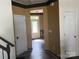 Hallway with neutral walls, leading to the front door, and featuring classic wood trim at 15005 Savannah Hall Dr # 72, Charlotte, NC 28273