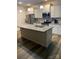 Bright kitchen with stainless steel appliances, white cabinets, a large island, and modern pendant lighting at 15005 Savannah Hall Dr # 72, Charlotte, NC 28273