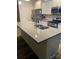 Modern kitchen with stainless steel appliances, white cabinets, a gray countertop, and a center island at 15005 Savannah Hall Dr # 72, Charlotte, NC 28273