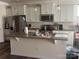 Bright kitchen features white cabinets, stainless steel appliances, and an island with seating at 15005 Savannah Hall Dr # 72, Charlotte, NC 28273