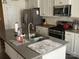 Modern kitchen features a large island with a sink and stainless steel appliances at 15005 Savannah Hall Dr # 72, Charlotte, NC 28273