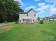 Expansive backyard with a pergola-covered patio, swing, fire pit, and lush lawn creating an outdoor oasis at 159 Autumn Mist Rd, Statesville, NC 28677