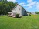 The backyard features a lovely lawn and a large deck with a pergola, perfect for outdoor living and entertaining at 159 Autumn Mist Rd, Statesville, NC 28677