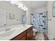 Bathroom with double sink vanity, shark-themed shower curtain, toilet, and decorative accents at 159 Autumn Mist Rd, Statesville, NC 28677