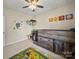 This ' bedroom features a ceiling fan, loft bed with storage, and a playful dinosaur-themed rug at 159 Autumn Mist Rd, Statesville, NC 28677