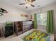 This ' bedroom features a ceiling fan, loft bed with storage, and a playful dinosaur-themed rug at 159 Autumn Mist Rd, Statesville, NC 28677