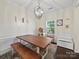 Cozy dining area featuring a rustic wood table and a stylish chandelier at 159 Autumn Mist Rd, Statesville, NC 28677