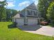 Two-story home with a spacious three-car garage, well-maintained lawn, and mature trees at 159 Autumn Mist Rd, Statesville, NC 28677