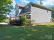 Charming two-story home showcasing lush landscaping with a well-manicured lawn and vibrant bushes at 159 Autumn Mist Rd, Statesville, NC 28677