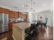 Open kitchen features granite island with seating, stainless appliances, and seamless flow into the adjacent dining area at 159 Autumn Mist Rd, Statesville, NC 28677