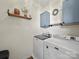 Well-lit laundry room features modern washer and dryer, shelving, and stylish decor for efficient chores at 159 Autumn Mist Rd, Statesville, NC 28677