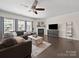 Spacious living room with a fireplace, plush sofa, and dark hardwood floors at 159 Autumn Mist Rd, Statesville, NC 28677