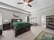 Spacious main bedroom with tray ceiling, ceiling fan, stylish decor, and ample natural light at 159 Autumn Mist Rd, Statesville, NC 28677