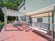 Covered patio with an outdoor swing and dining table, seamlessly blending indoor comfort with outdoor living at 159 Autumn Mist Rd, Statesville, NC 28677