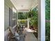Relaxing front porch featuring comfortable seating, decorative pillows, and a hanging fern at 159 Autumn Mist Rd, Statesville, NC 28677