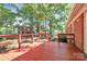 A large back deck outside a brick home, surrounded by trees and a storage shed at 16509 Kimbolten Dr, Huntersville, NC 28078