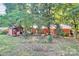A cozy backyard setting with a brick home, a deck, and a detached shed at 16509 Kimbolten Dr, Huntersville, NC 28078