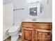 Bathroom featuring wood vanity, toilet, and bathtub with modern fixtures at 16509 Kimbolten Dr, Huntersville, NC 28078