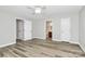 Spacious bedroom with neutral walls, ceiling fan and hardwood floors at 16509 Kimbolten Dr, Huntersville, NC 28078