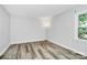 Cozy bedroom with wood floors and a window that provides natural light at 16509 Kimbolten Dr, Huntersville, NC 28078