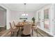 Elegant dining room featuring a modern chandelier and doors that lead to the outside at 16509 Kimbolten Dr, Huntersville, NC 28078
