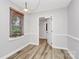 Dining room with wood floors, a window with blinds, and neutral wall paint at 16509 Kimbolten Dr, Huntersville, NC 28078