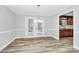 Open dining room area with light walls, wood-look floors, and a chandelier at 16509 Kimbolten Dr, Huntersville, NC 28078