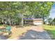 Brick home with long driveway and lush green trees at 16509 Kimbolten Dr, Huntersville, NC 28078