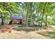 Beautiful brick home surrounded by mature trees and landscaped yard at 16509 Kimbolten Dr, Huntersville, NC 28078