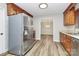 Well-equipped kitchen with stainless steel refrigerator and wooden cabinets, overlooking an open area at 16509 Kimbolten Dr, Huntersville, NC 28078