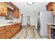 Kitchen with stainless steel appliances, wood cabinetry, and hardwood flooring at 16509 Kimbolten Dr, Huntersville, NC 28078