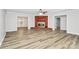 An open concept living room with a brick fireplace and hardwood floors at 16509 Kimbolten Dr, Huntersville, NC 28078