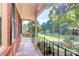 Covered porch with brick flooring and wrought iron railing overlooking the street at 16509 Kimbolten Dr, Huntersville, NC 28078