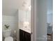 Bathroom with leafy wallpaper above the wood paneling, modern sink, and toilet at 1736 Rhynes Trl, Rock Hill, SC 29732