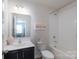 Bright bathroom with vanity, toilet, and bathtub with tile surround at 1736 Rhynes Trl, Rock Hill, SC 29732