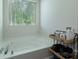 Bright bathtub with a large window, caddy and a shower head at 1736 Rhynes Trl, Rock Hill, SC 29732