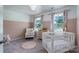 This charming Bedroom features a white crib, area rug, dresser, and windows with natural light at 1736 Rhynes Trl, Rock Hill, SC 29732