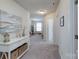 Hallway with white walls, carpet, and a white console table with decorative items at 1736 Rhynes Trl, Rock Hill, SC 29732