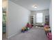 Playroom with carpet, two bookshelves, and a window with toys and books at 1736 Rhynes Trl, Rock Hill, SC 29732