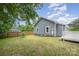 Backyard featuring well-maintained lawn, partial fence and siding on the home's exterior at 201 Valley St, Stanley, NC 28164