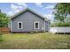 View of the home's backyard with blue siding and a small, elevated deck at 201 Valley St, Stanley, NC 28164