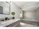 Well-appointed bathroom with granite countertop vanity and a separate soaking tub at 201 Valley St, Stanley, NC 28164