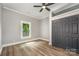 Bright bedroom with hardwood floors, a window overlooking the yard, and spacious closet space at 201 Valley St, Stanley, NC 28164