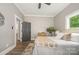 Cozy bedroom features a ceiling fan, stylish decor, and ample natural light from the window at 201 Valley St, Stanley, NC 28164