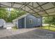 View of home with metal carport over gravel area, home has light blue siding at 201 Valley St, Stanley, NC 28164