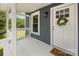Inviting front porch with a 'Home Sweet Home' doormat and a decorative wreath on the front door at 201 Valley St, Stanley, NC 28164